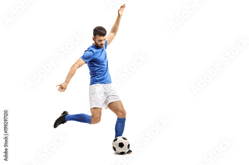 Soccer player kicking a football