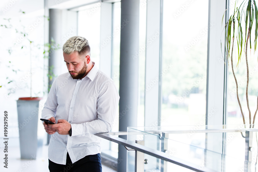 Young Stylish Businessman Using Smartphone At Break