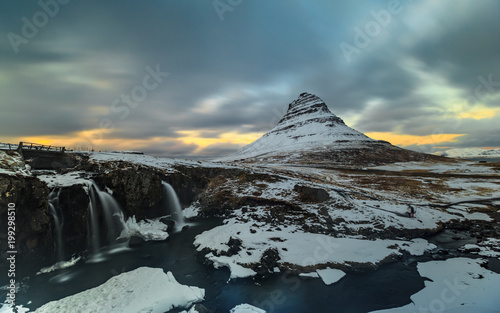 Long exposure of mountain with waterfall foreground in winter