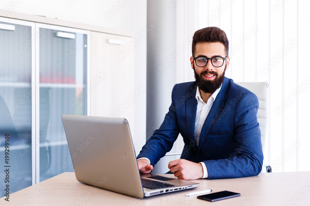 Young Businessman Working On Laptop At Office Young Businessman Working On Laptop At Office