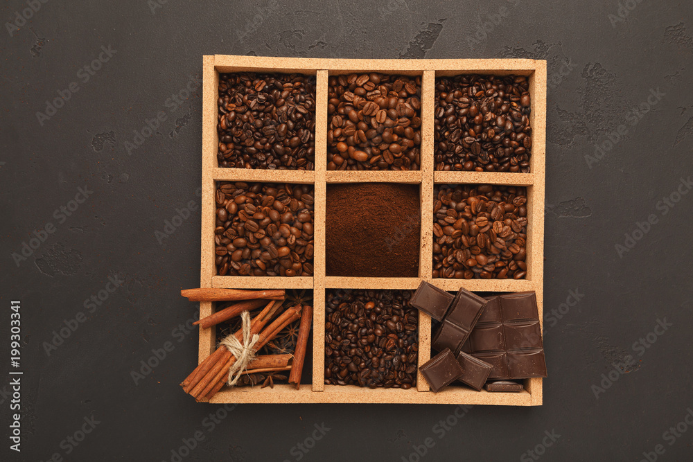 Top view on scattered coffee beans and spices, background with c Top view on scattered coffee beans and spices, background with c