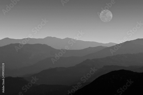 black and white mountain ranges with super moon