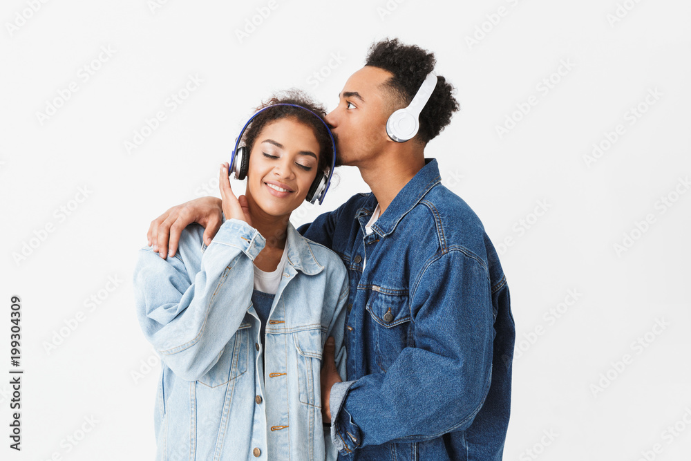 Happy lovely african couple in denim shirts posing together Happy lovely african couple in denim shirts posing together