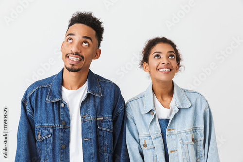 Happy couple in denim shirts posing together and looking up