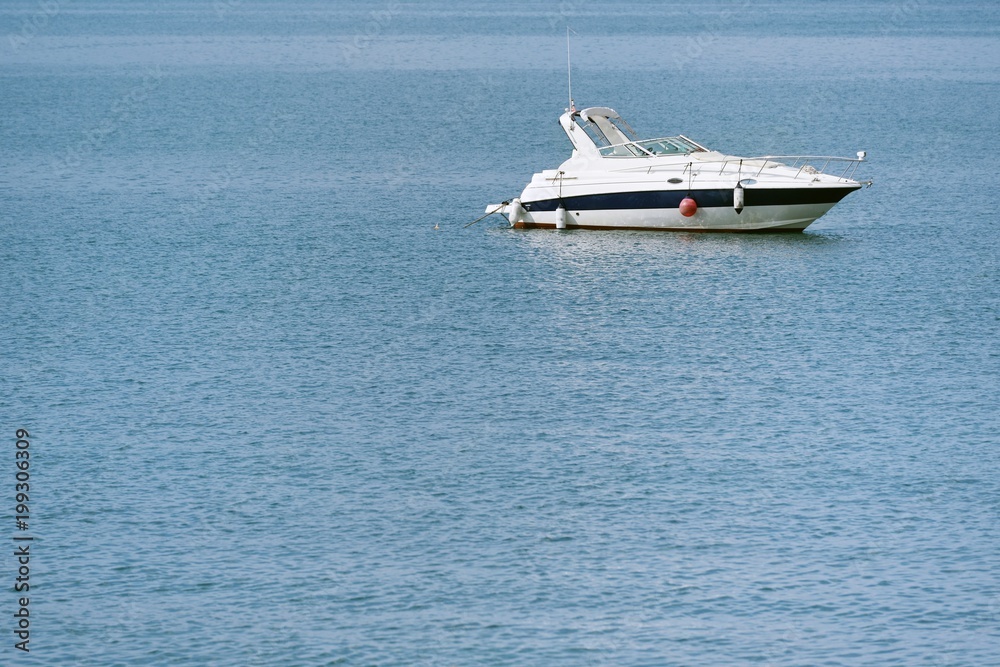 A small beautiful white yacht, just standing in the sea A small beautiful white yacht, just standing in the sea