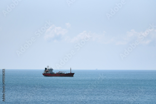 A ship tanker stands without traffic, a ship on a blue sky background
