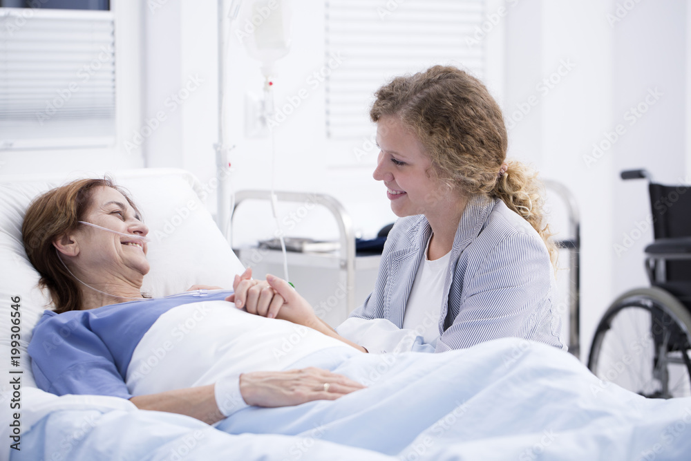 Woman visiting mum in hospital Woman visiting mum in hospital