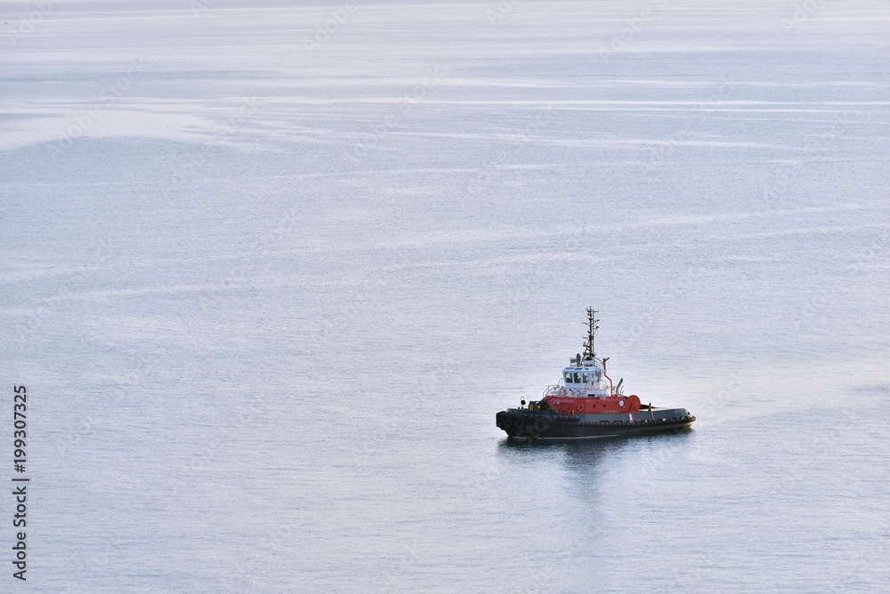 Tug boat stands without traffic in the sea. Tug boat alone in the sea Tug boat stands without traffic in the sea. Tug boat alone in the sea