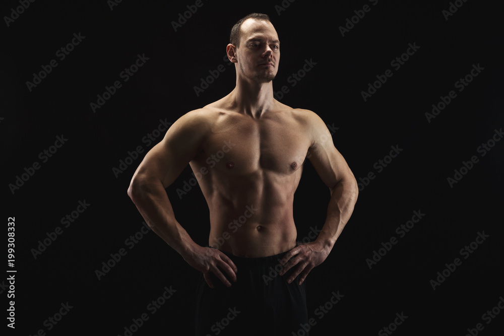 Strong athletic man showes naked muscular body Strong athletic man showes naked muscular body