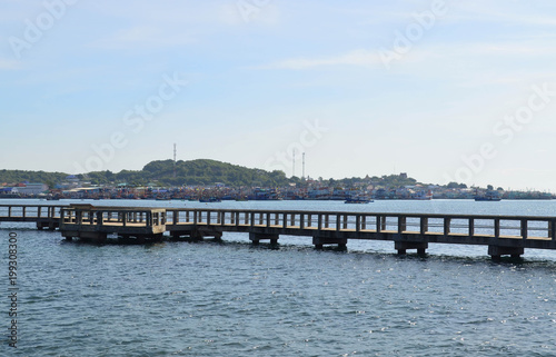 Walkway cement bridge over the sea and shore background © ubonwanu