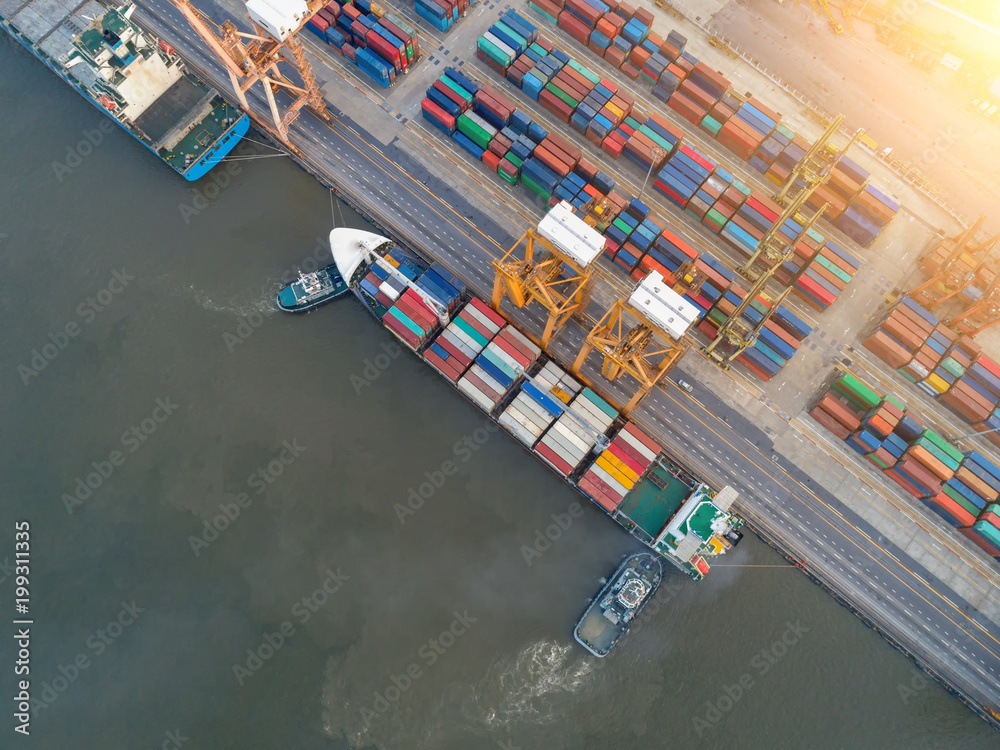 Aerial view of business port with shore crane loading container in container ship in import/export and business logistics with crane and shipping cargo.