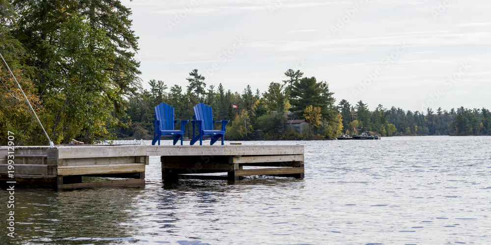 Adirondack chairs on a dock, Kenora, Lake of The Woods, Ontario, Canada Adirondack chairs on a dock, Kenora, Lake of The Woods, Ontario, Canada