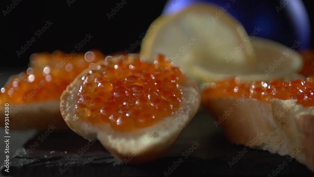Close-up of red caviar on bread with butter. Close-up of red caviar on bread with butter.