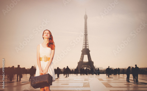 Beautiful redhead woman from province has come to conquer Paris. Eiffel tower on background © Masson