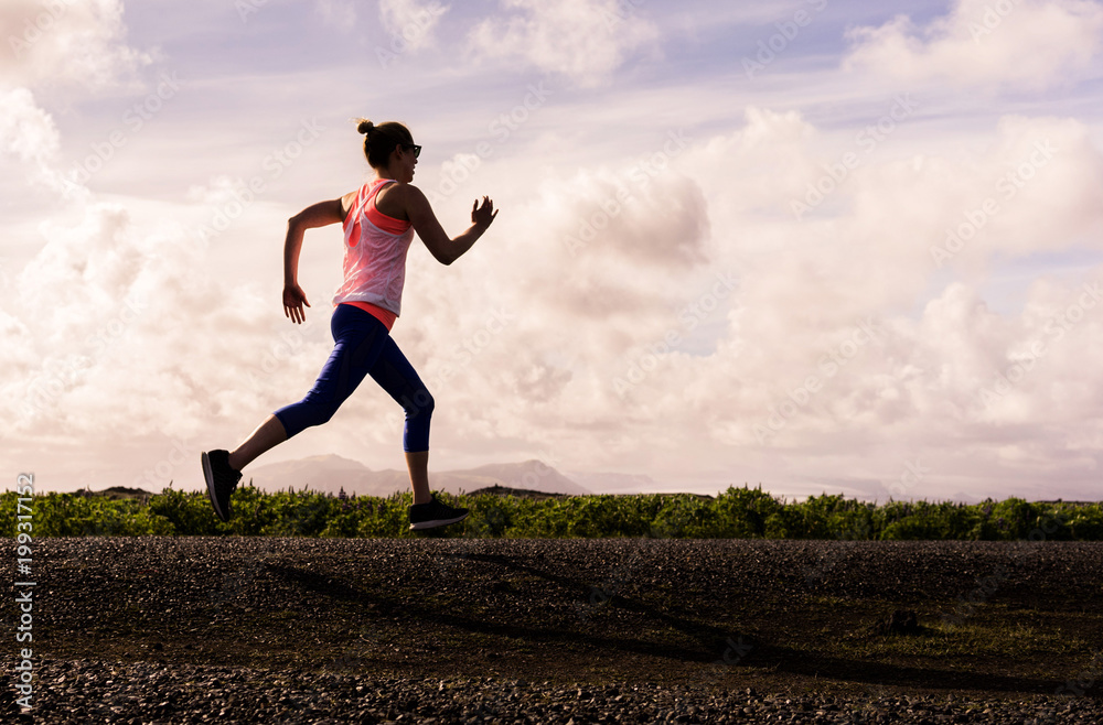 Woman road running in the evening