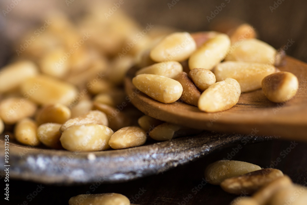 Pine Nuts on Dark Wooden Table. Toasted Organic Healthy Food. Pine Nuts on Dark Wooden Table. Toasted Organic Healthy Food.