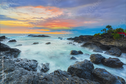 Beautiful Sunset at Menganti beach of Indonesia, Sunset and rocks on the beach