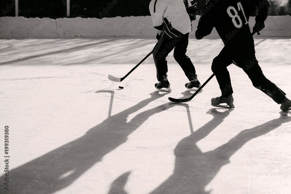 Fototapeta premium men play hockey on the rink during the day