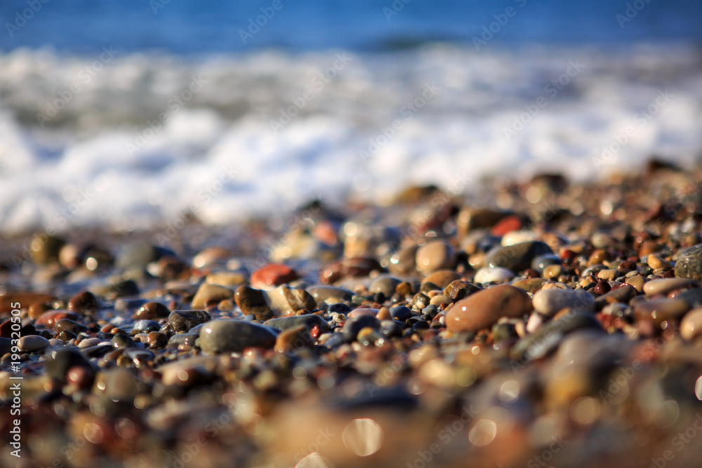 Waves washing over gravel beach, macro shot. Waves washing over gravel beach, macro shot.