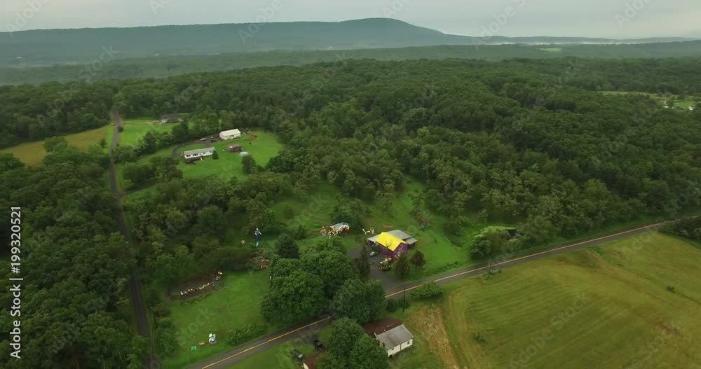 Orbiting aerial views of an eccentric’s collection of giant American roadside attractions and oddities like Muffler Man, Brian the Beach Boy, giant apple, crab, the Simpsons riding a train around Sant