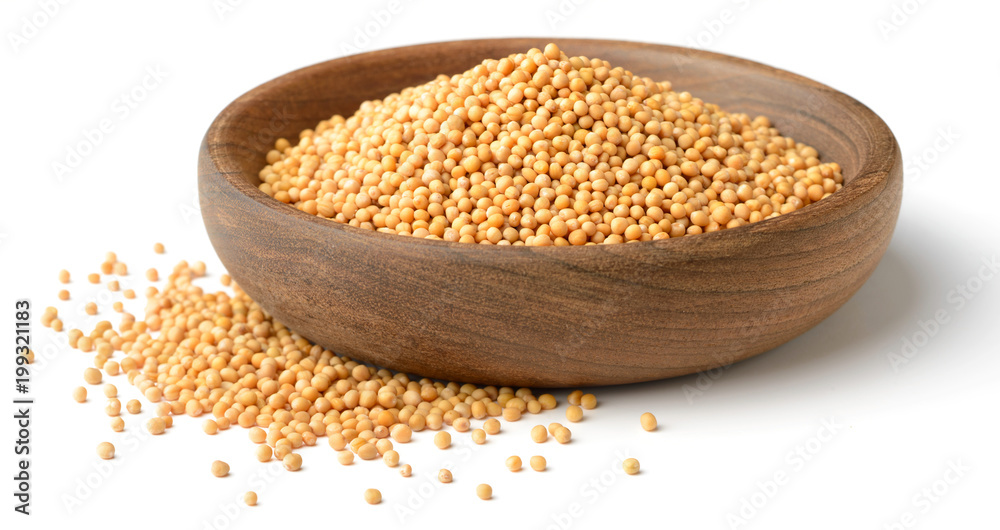 yellow mustard seeds in the wooden plate, isolated on white yellow mustard seeds in the wooden plate, isolated on white