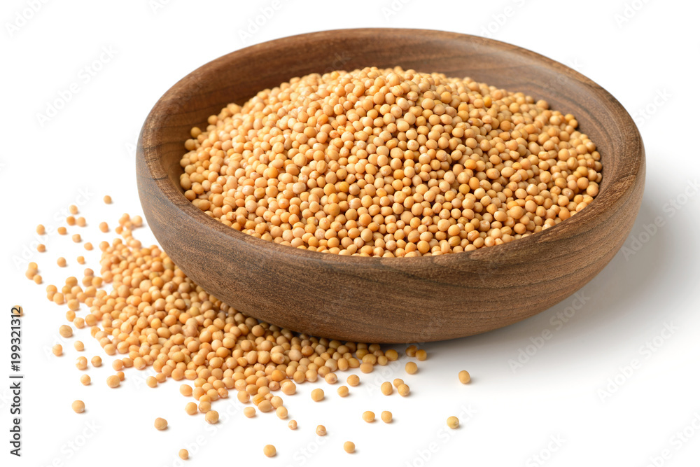 yellow mustard seeds in the wooden plate, isolated on white yellow mustard seeds in the wooden plate, isolated on white