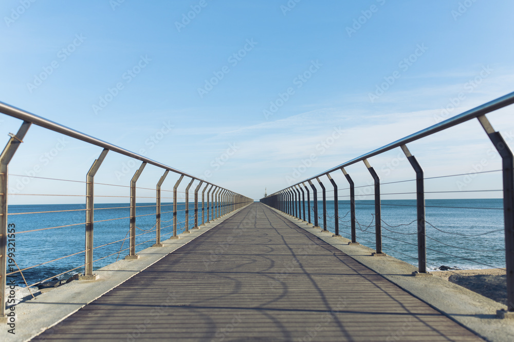 Diminishing perspective of pier over sea against sky Diminishing perspective of pier over sea against sky