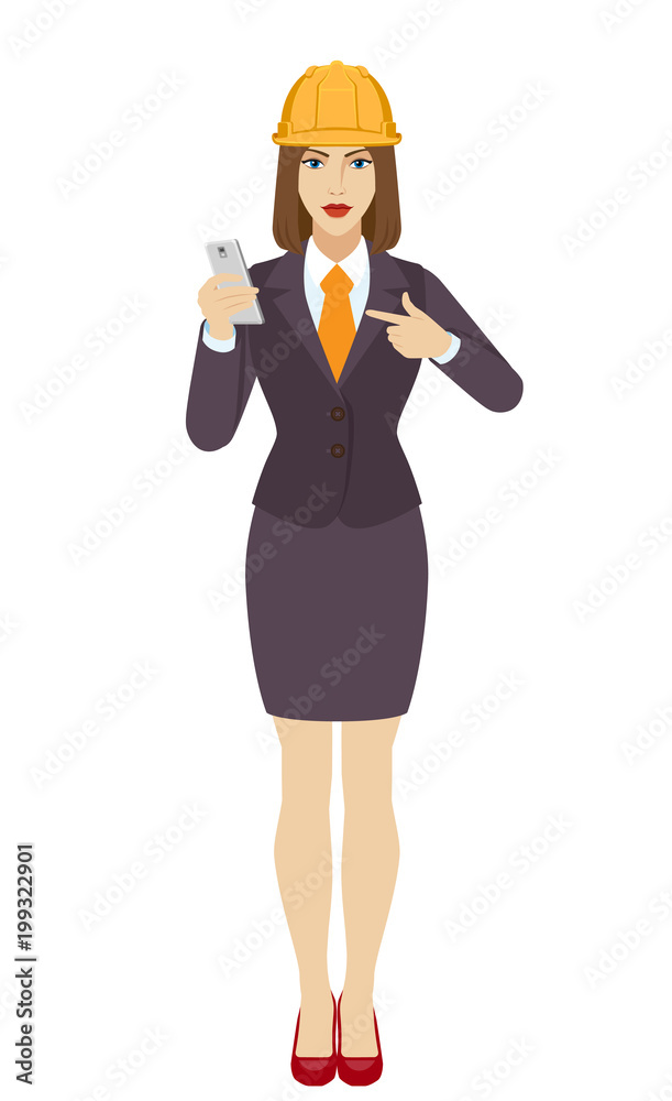 Businesswoman in construction helmet pointing at a mobile phone Businesswoman in construction helmet pointing at a mobile phone