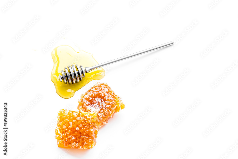 Honey background. Honey dipper and honeycomb on white background top view copy space Honey background. Honey dipper and honeycomb on white background top view copy space