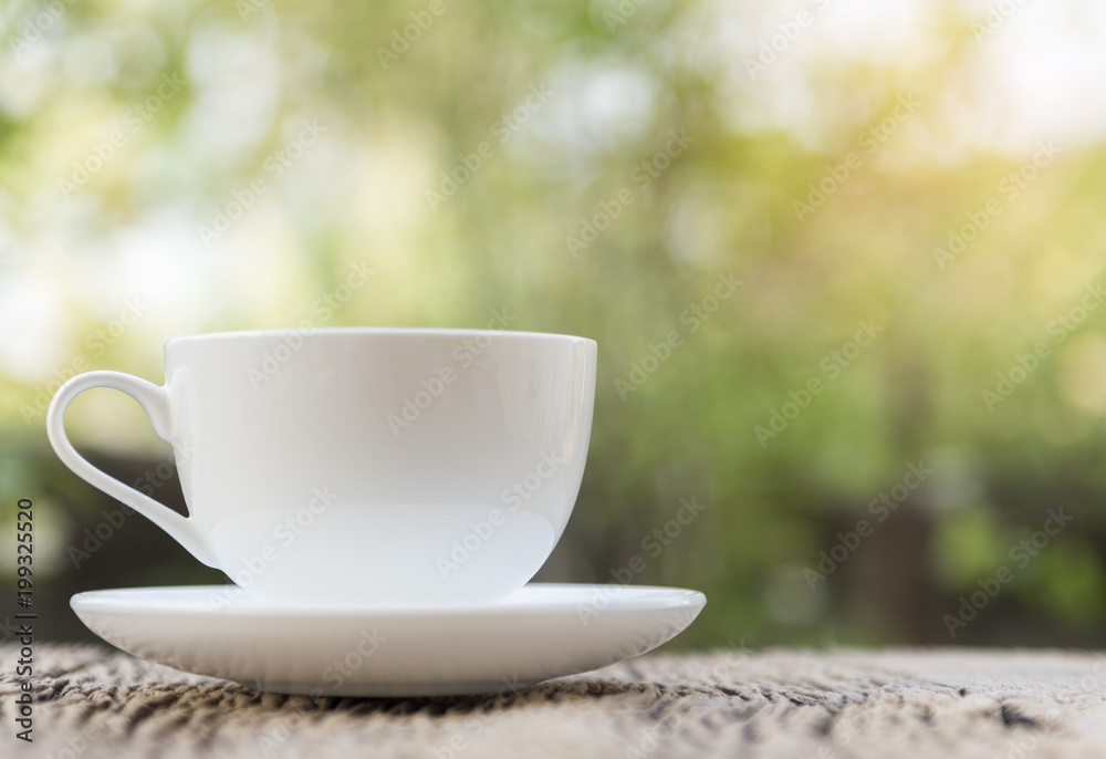 Close up white coffee cup on the table at morning time Close up white coffee cup on the table at morning time