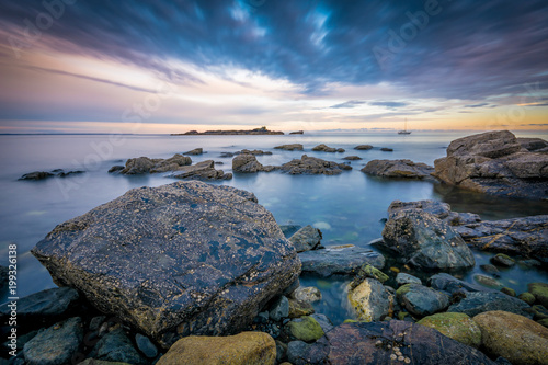 Clear calm ocean around the rocks at picturesque Mousehole, Cornwall photo