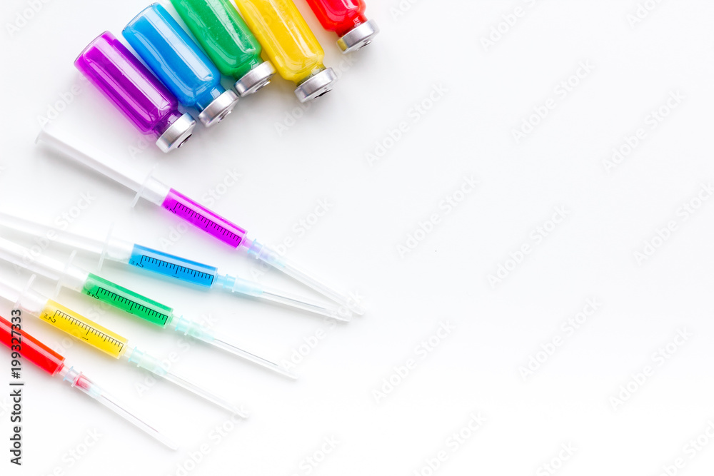 Syringe with colored drug. Injection concept on white background top view copy space Syringe with colored drug. Injection concept on white background top view copy space