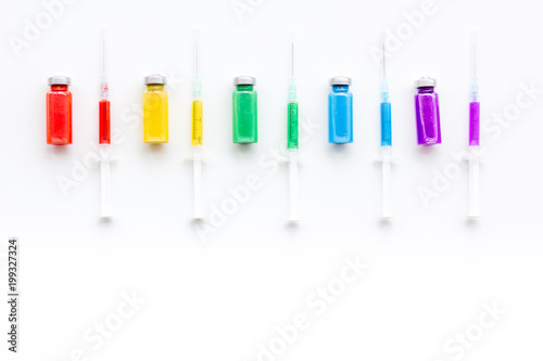 Syringe with colored drug. Injection concept on white background top view pattern