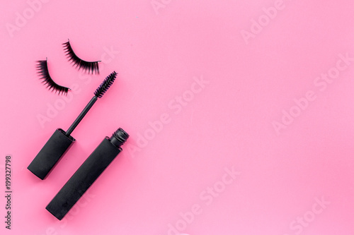 Fototapeta Naklejka Na Ścianę i Meble -  Basic products for eyelashes makeup. Mascara and false eyelashes on pink background top view copy space