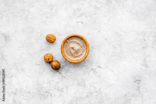 Foto Homemade spa with organic scrub and walnut on stone background top view space fo