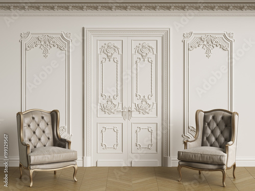 Classic armchais in classic interior. Walls with moldings and decorated cornice