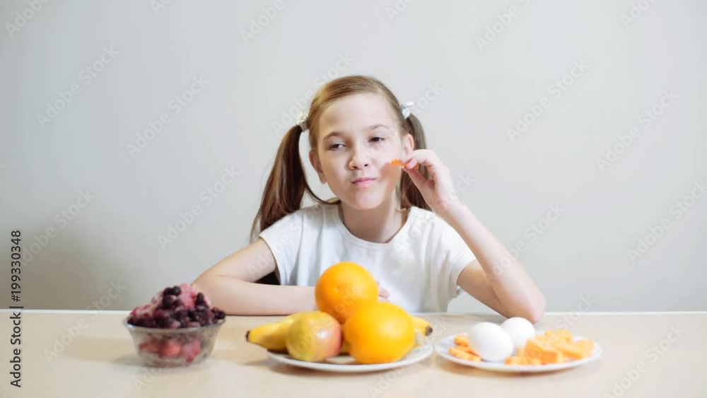 The girl eats carrots, sliced by rings, sitting at the kitchen table. Vegetarianism, Healthy Eating, Healthy Vegetables, Healthy Eating, Baby Food, Wellness The girl eats carrots, sliced by rings, sitting at the kitchen table. Vegetarianism, Healthy Eating, Healthy Vegetables, Healthy Eating, Baby Food, Wellness