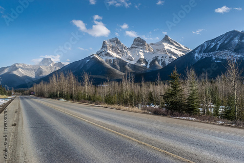 Road and Three Sisters mountains, adventure and travel. Canmore, Canada