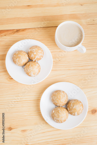 gingerbread on plates and coffee wiht milk on a wooden background. breakfast or snack