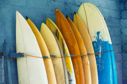 Canvas Print Set of different color surf boards in a stack by ocean.Bali,Indo