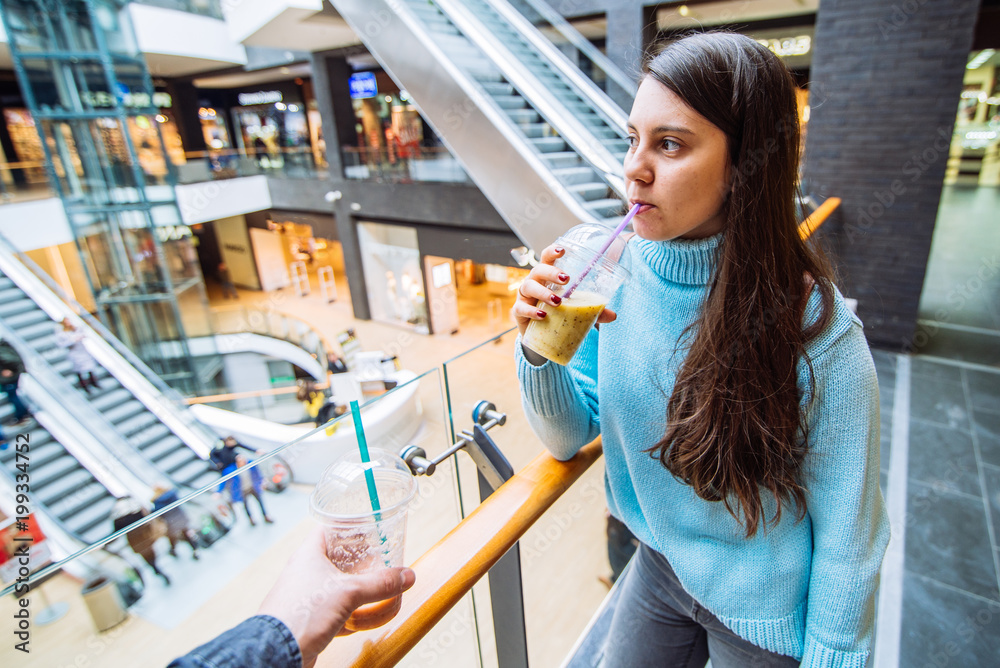 couple in mall make shopping. drink smoothies. lifestyle concept