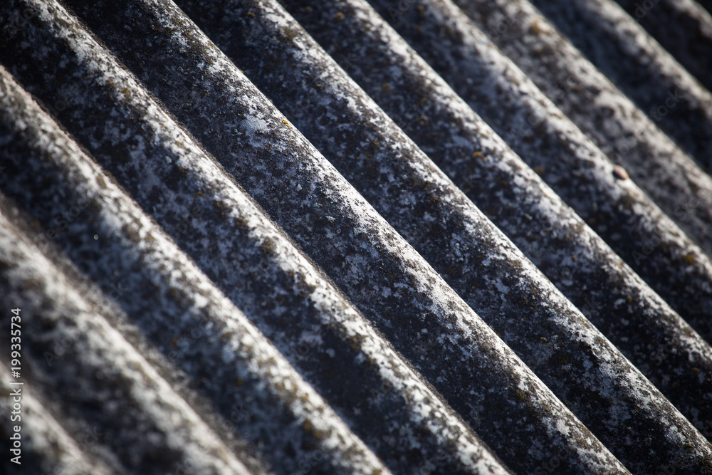 Texture of a slate on an old roof close-up. Sunny day. Texture of a slate on an old roof close-up. Sunny day.