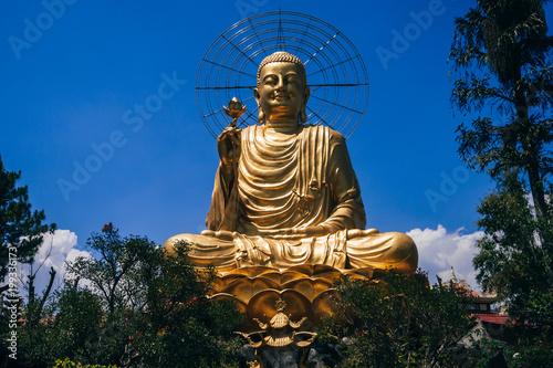 Statue of Big Golden Sitting Buddha in Dalat, Vietnam photo