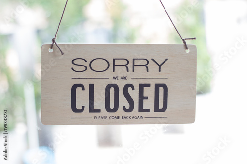A sign hanging off Coffee shop door,Close sign blur background,Label word close photo