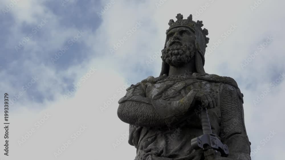 Fast motion clouds behind a statue of Robert the Bruce, Scottish king. Fast motion clouds behind a statue of Robert the Bruce, Scottish king.