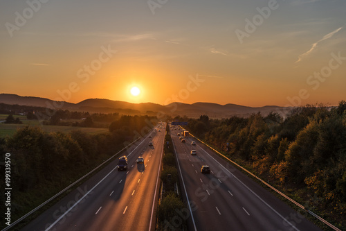 The road traffic on a motorway at sunset