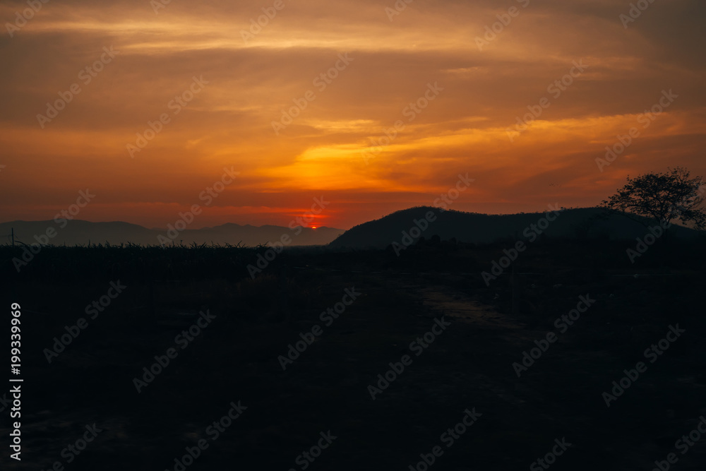 orange sunrise on the background of the silhouette of the mountains