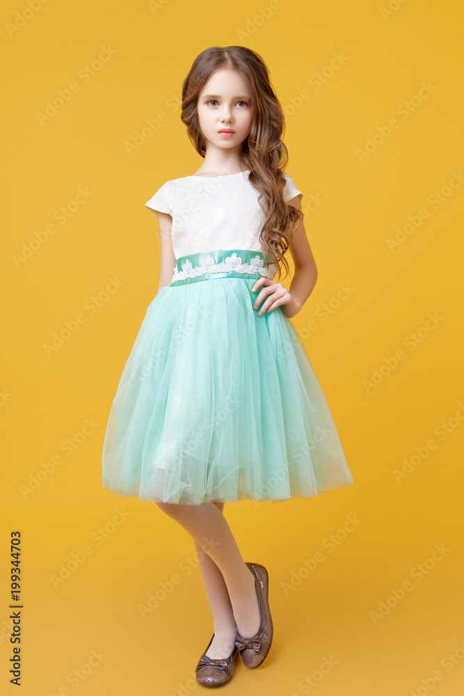 Little girl model in studio on yellow background Little girl model in studio on yellow background