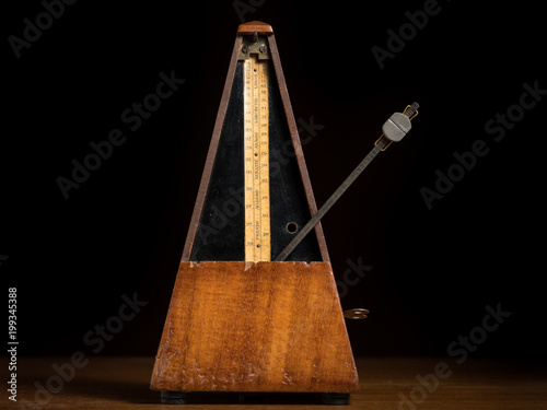 Detail of an old mechanic musical metronome photo