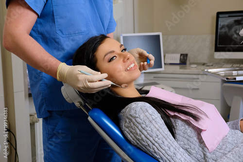 Dentist curing a female patient in a dentist office. Dentistry care woman visit